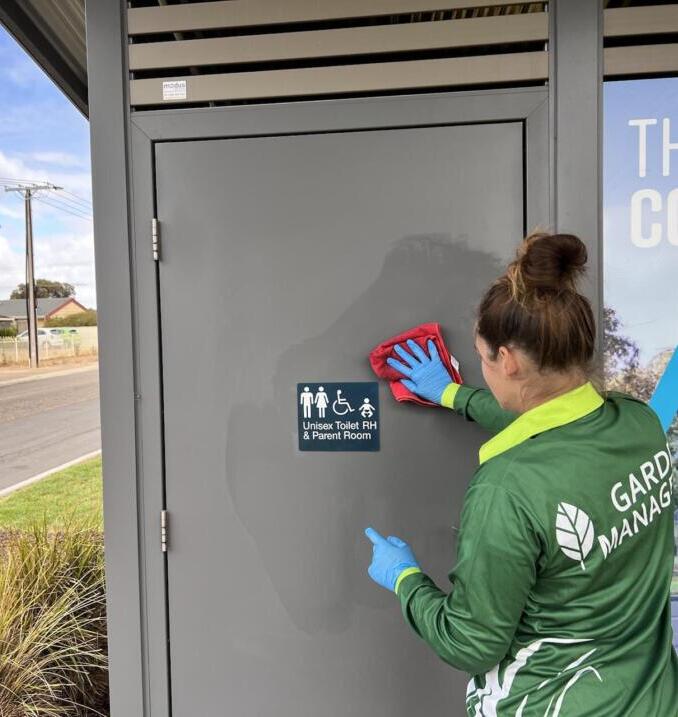 At first light, a uniformed Garden Managers crew edges lawns, clears litter and deep-cleans a council toilet block, readying the park for its early-morning visitors.